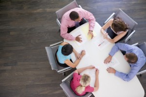 Five businesspeople at boardroom table